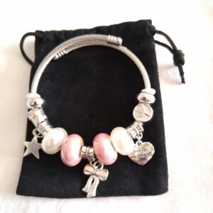 Pink and silver coloured charm bracelet with hanging heart, star and bow with white & rose coloured beads