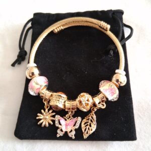 Pink and gold coloured charm bracelet with hanging butterfly, flower and leaf