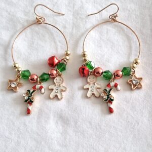 Gold coloured hoop earrings with hanging decoration including gingerbread man and mini bells